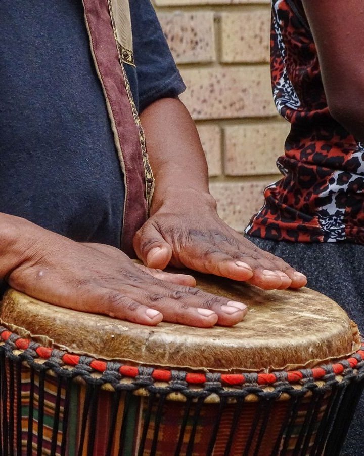 Hands on a djembe drum