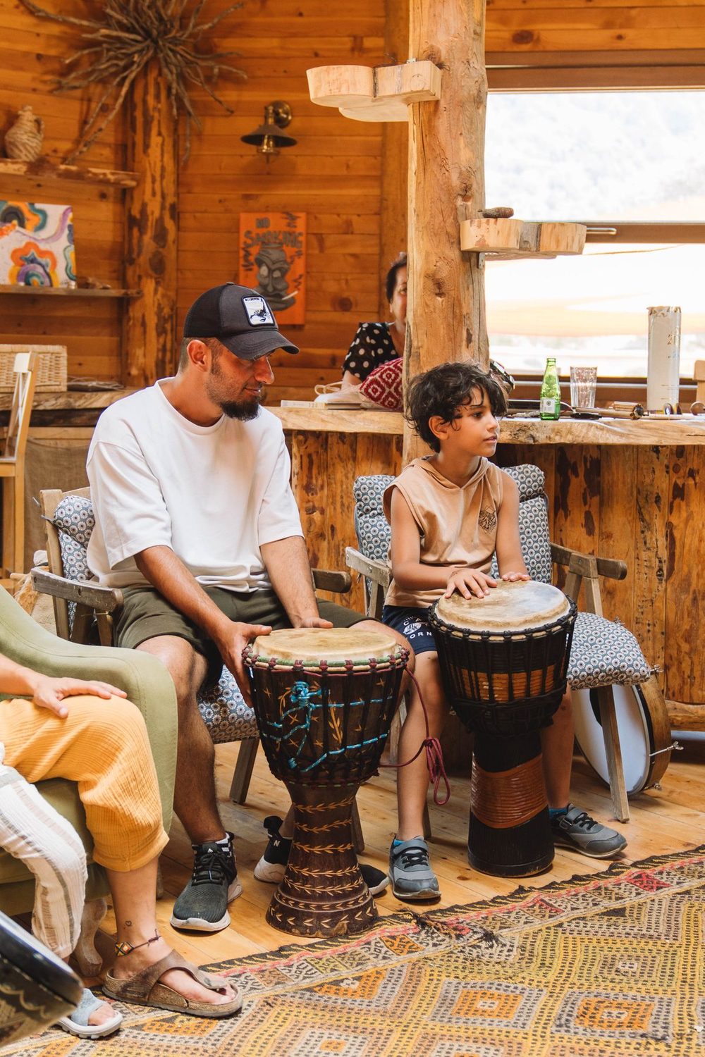 A man and a boy sitting with drums